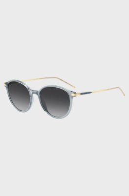 Lunettes de soleil bleu-gris avec branches dor&eacute;es, bleu clair