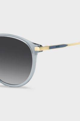 Lunettes de soleil bleu-gris avec branches dor&eacute;es, bleu clair
