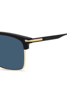  Blue-lens sunglasses with black and gold-tone frames, Black