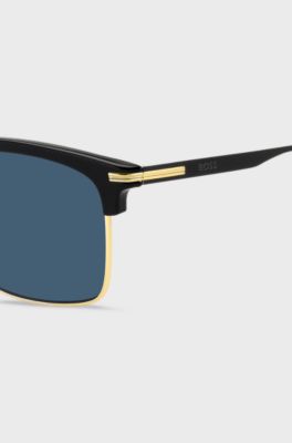  Blue-lens sunglasses with black and gold-tone frames, Black