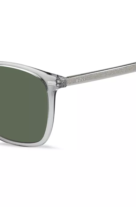 Transparent-graue Sonnenbrille mit Logo an den Bügeln