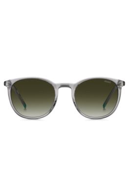 Transparent-grey sunglasses with green logo, Lysegr&aring;