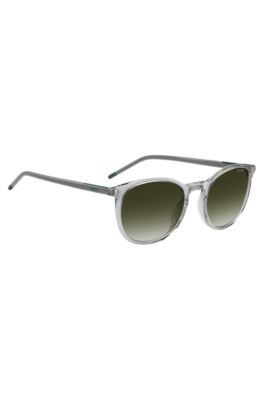 Transparent-grey sunglasses with green logo, Lysegr&aring;