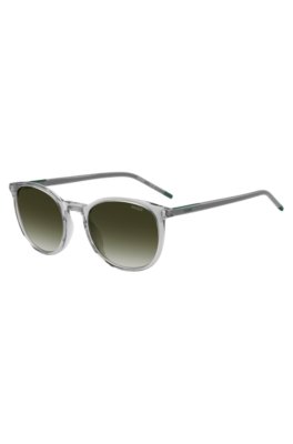 Transparent-grey sunglasses with green logo