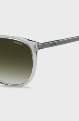 Transparent-graue Sonnenbrille mit gr&uuml;nem Logo, Hellgrau