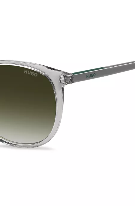 Transparent-grey sunglasses with green logo