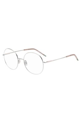 Round optical frames with rose-coloured trims