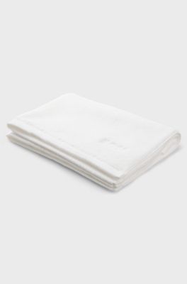 Cotton bath mat with contrast embroidered logo, White