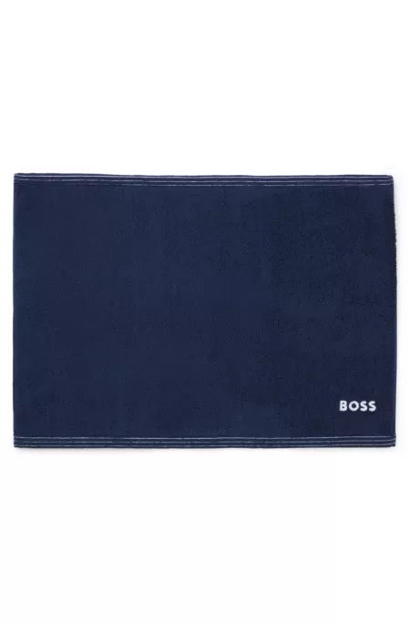 Cotton bath mat with contrast embroidered logo