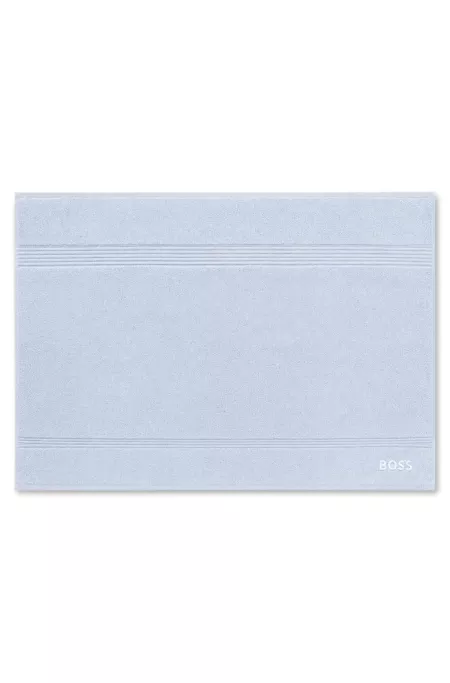 Cotton bath mat with embroidered logo