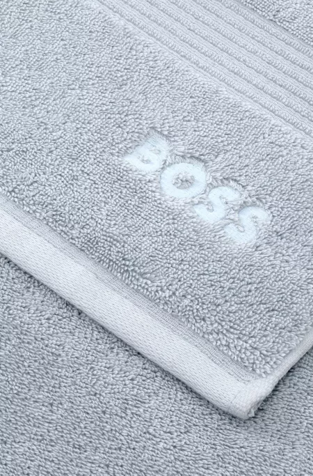 Cotton bath mat with embroidered logo