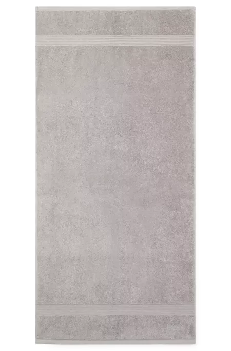 Cotton bath towel in silver with embroidered logo