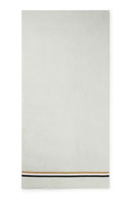 Cotton bath towel with signature-stripe border