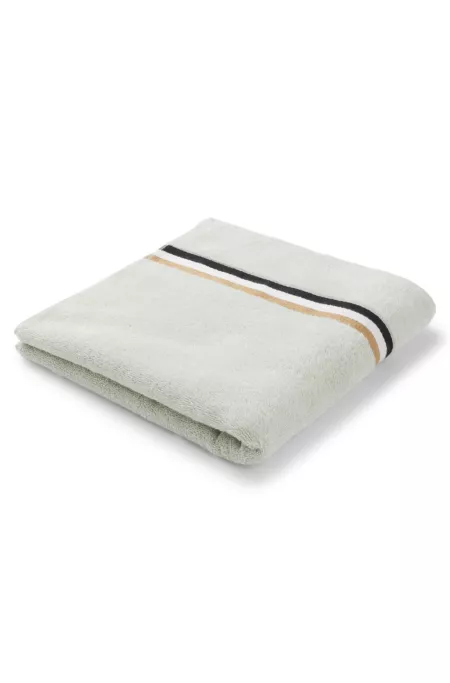 Cotton bath towel with signature-stripe border