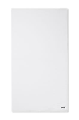 Honeycomb-cotton bath towel with signature-stripe strap, White