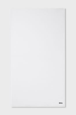 Honeycomb-cotton bath towel with signature-stripe strap, White