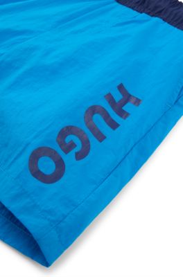 Kids' quick-dry swim shorts with vertical logo, Blue