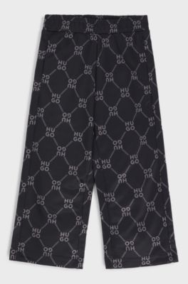 Kids' loose-fit tracksuit bottoms with stacked-logo print, Patterned