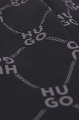 Kids' loose-fit tracksuit bottoms with stacked-logo print, Patterned