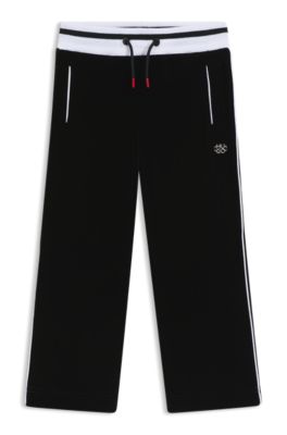 Kids' tracksuit bottoms in stretch velvet with striped ribbing, Black