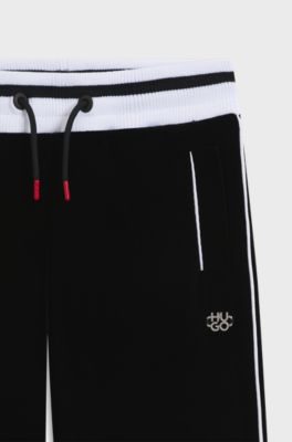 Kids-Jogginghose aus Stretch-Samt mit gestreiften Rippb&uuml;ndchen, Schwarz