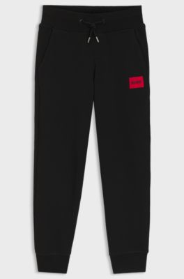 Kids' fleece tracksuit bottoms with logo label, Black