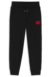 Kids' fleece tracksuit bottoms with logo label, Black