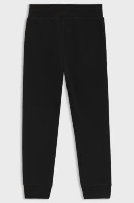 Kids' fleece tracksuit bottoms with logo label, Black