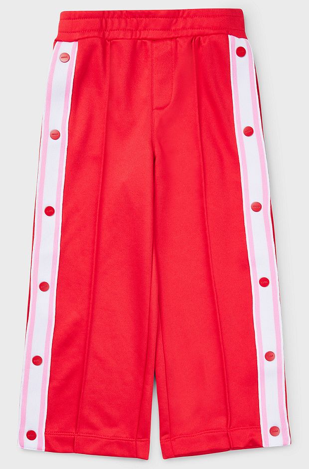 Kids' tracksuit bottoms with press-stud side seams, Red