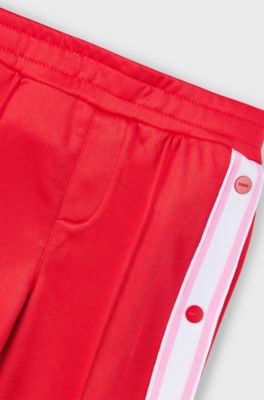 Pantaloni della tuta per bambini con bottoni automatici sulle cuciture laterali, Rosso