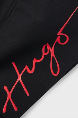 Kids' cuffed tracksuit bottoms with branding and patch pocket, Black