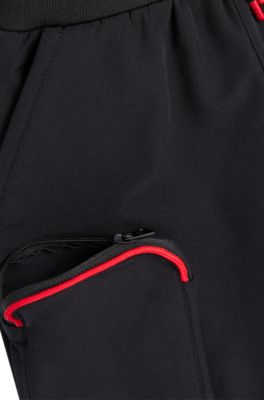 Kids' cuffed tracksuit bottoms with branding and patch pocket, Black