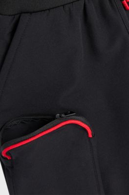 Kids' cuffed tracksuit bottoms with branding and patch pocket, Black