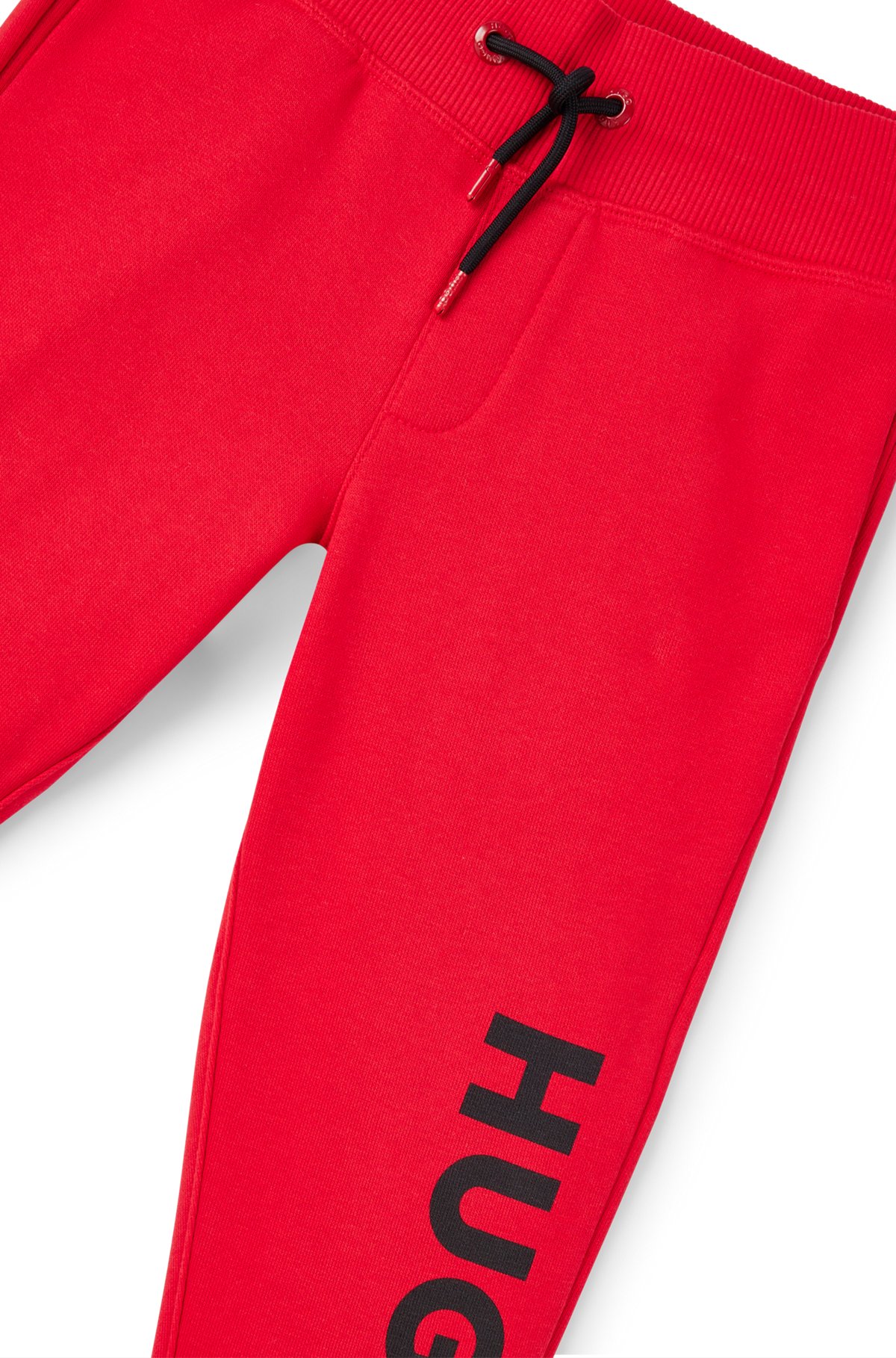 Kids' fleece tracksuit bottoms with vertical logo, Red
