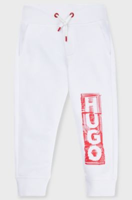 Kids' fleece tracksuit bottoms with marker-style logo, White