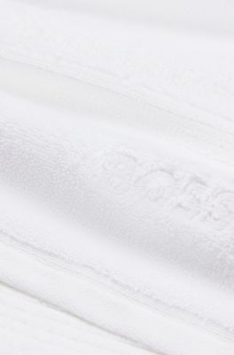 White cotton guest towel with embroidered logo, White