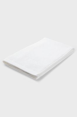Cotton guest towel with contrast embroidered logo, White