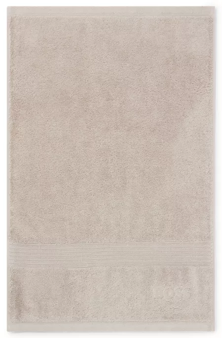 Aegean-cotton guest towel with tonal logo