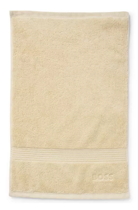 Aegean-cotton guest towel with tonal logo