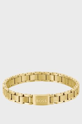 Gold-tone cuff with engraved logo, Gold tone