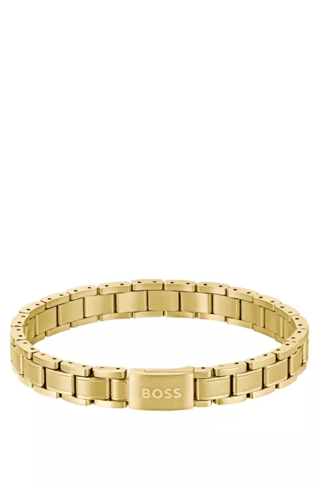 Gold-tone cuff with engraved logo