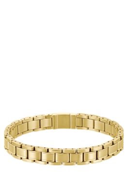 Gold-tone cuff with engraved logo, Gold tone