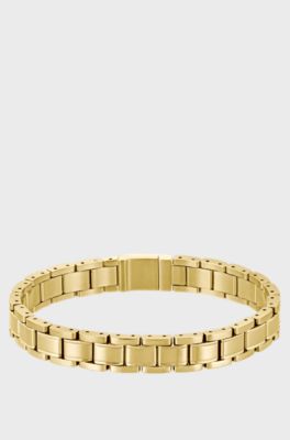 Gold-tone cuff with engraved logo, Gold tone