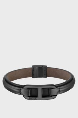 Layered leather cuff with branded black metallic link, Black