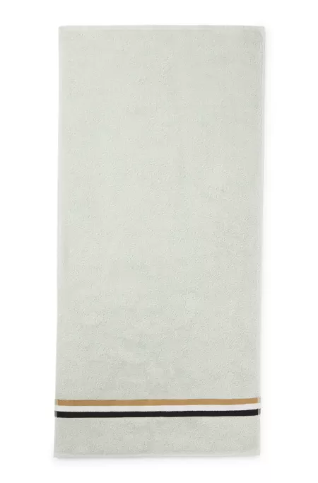 Cotton hand towel with signature-stripe border