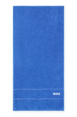 Handduk i bomull med broderad vit logga, Bl&aring;