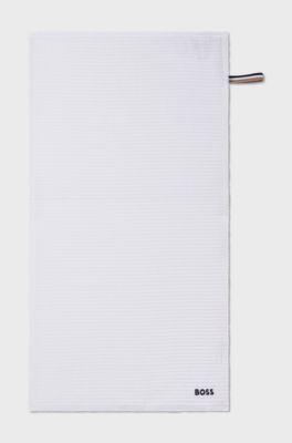 Honeycomb-cotton hand towel with signature-stripe strap, White