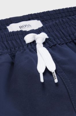 Kids' quick-drying swim shorts with stripe and logo, Dark Blue
