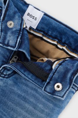 Jeans per bambini in denim elasticizzato con tasca posteriore brandizzata, A disegni