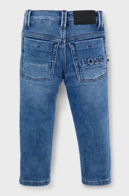Jeans per bambini in denim elasticizzato con tasca posteriore brandizzata, A disegni